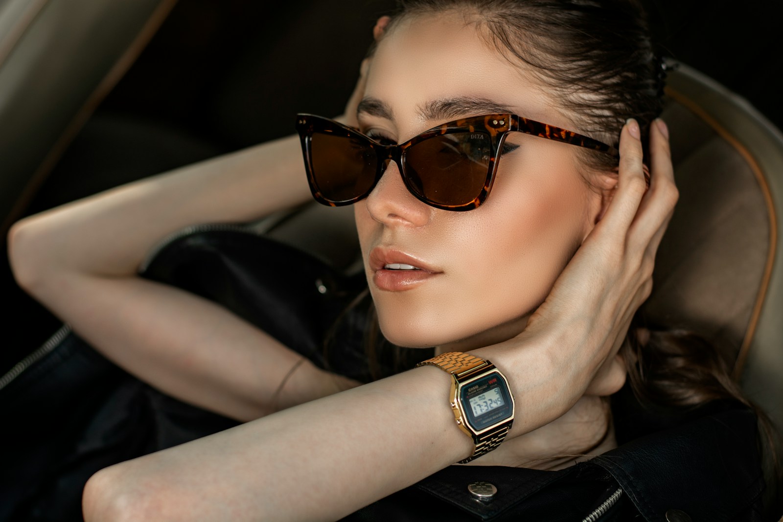 a woman wearing sunglasses sitting in a car